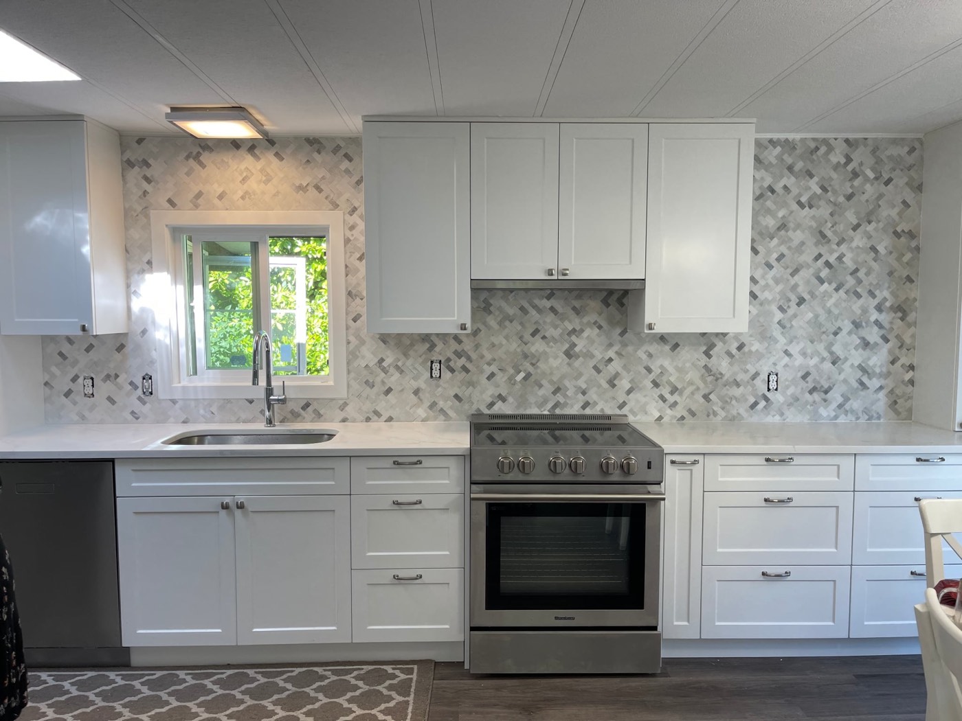 Marble herringbone mosaic backsplash